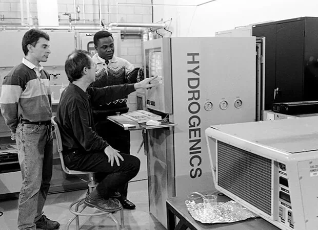 Trois chercheurs devant un électrolyseur Hydrogenics dans les laboratoires de l'Institut de recherche sur l'hydrogène, en 1999
